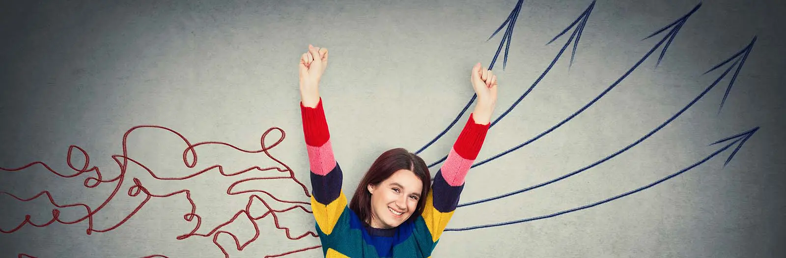 Woman raising her arms with joy after Neurofeedback treatment